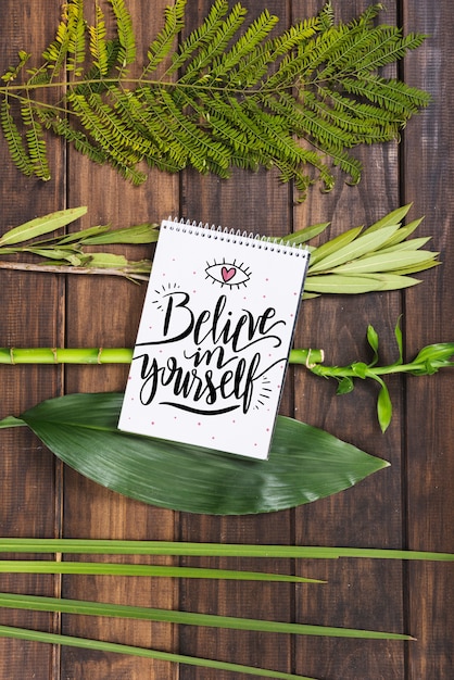 notepad mockup with tropical leaves