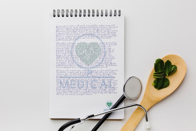 notepad with mint leaves flat lay