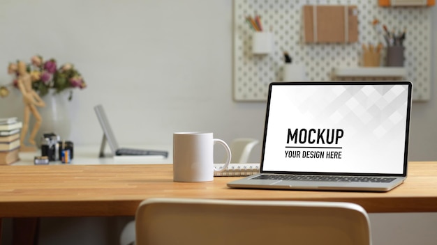 office room with laptop mockup on the table with office supplies
