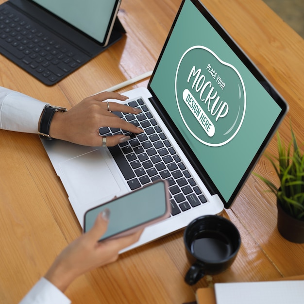 PSD office worker using laptop mockup, tablet and supplies