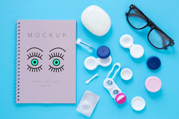 optics still life arrangement with notebook mock-up