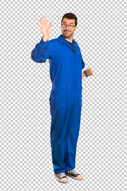 Painter man saluting with hand with happy expression