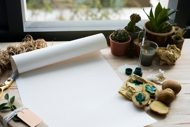 painting paper cactus plants on a wooden table