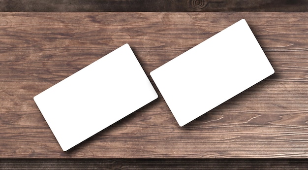 Pair of business cards on a wooden table realistic mockup