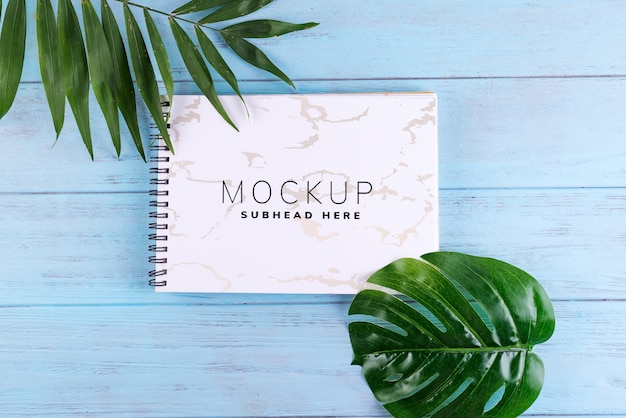 Palm leaves and a paper notebook 