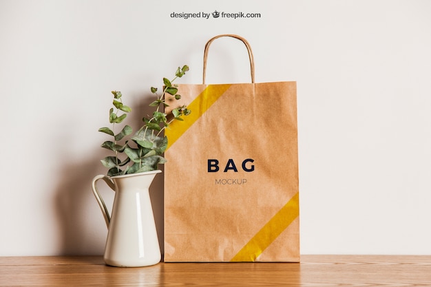 PSD paper bag mockup next to flower pot