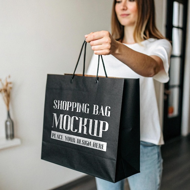 Paper bag on woman hand black bag mockup