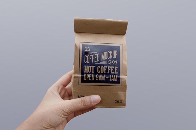 Paper coffee bag mockup on hand