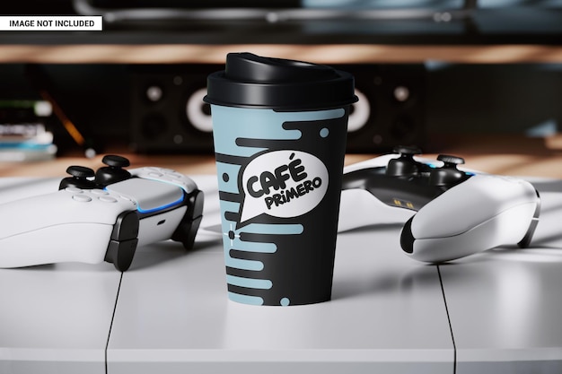 PSD paper coffee cup on the table near the gamepads mockup