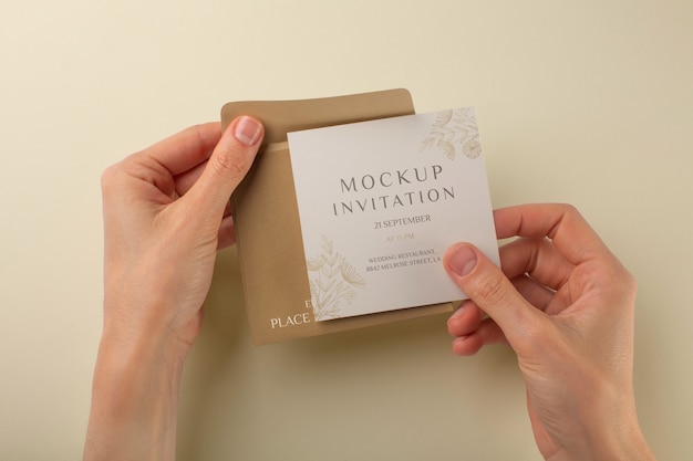 PSD paper invitation mock-up held by hands