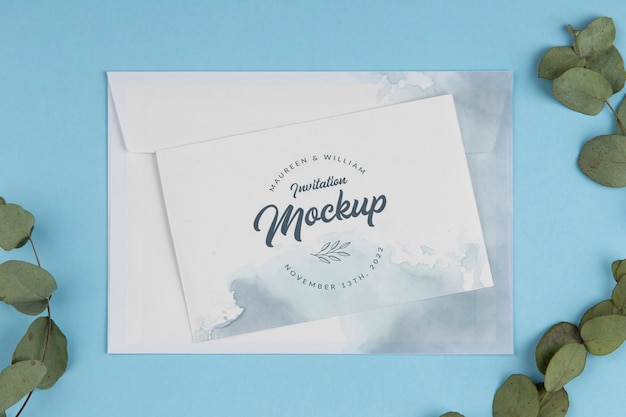 Paper invitation mock-up with watercolor design and leaves