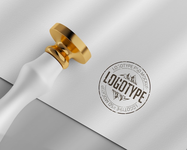 PSD paper logo mockup with gold round rubber stamp