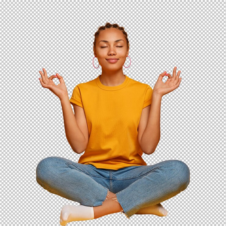 PSD peaceful calm dark skinned female model sits crossed legs on floor practices yoga and tries to relax breathes deeply closes eyes reaches nirvana holds hands sideways releases stress after work