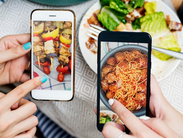 People sharing food photos on mobile phone