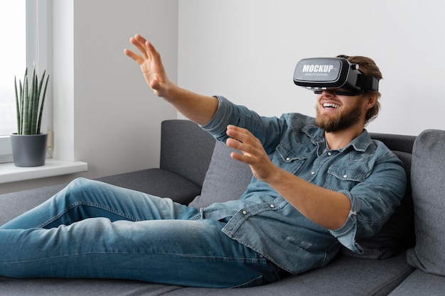 Person having fun at home with vr glasses mockup