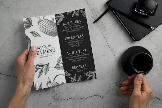 Person holding bifold brochure mock-up