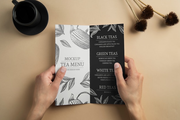 Person holding bifold brochure mock-up