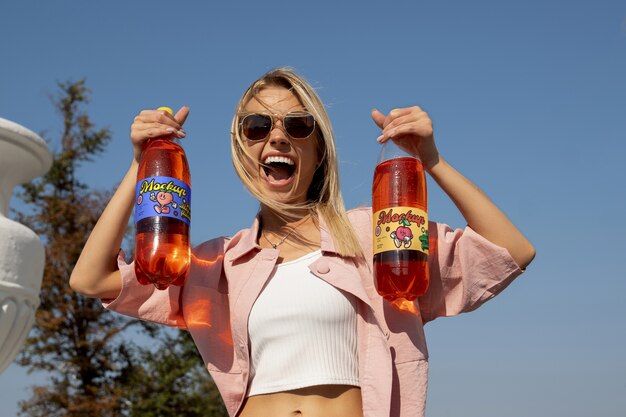 Person holding bottle of 1,5 litres mockup design