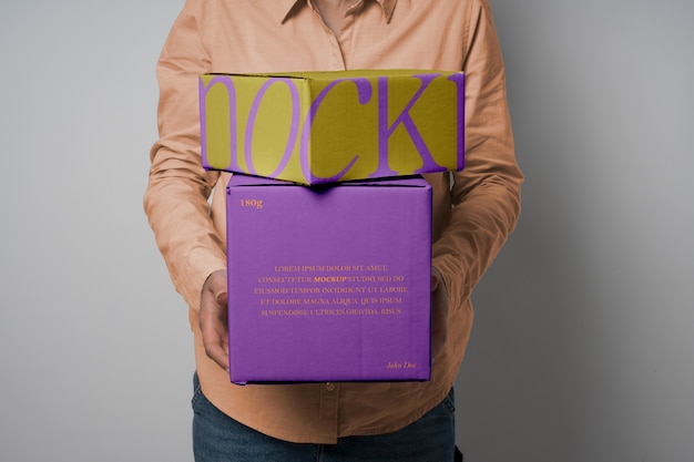 PSD person holding boxes mockup