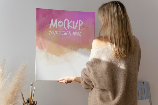 PSD person holding a canvas mock-up