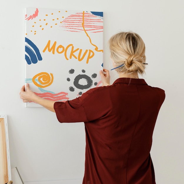 person holding a canvas mock-up