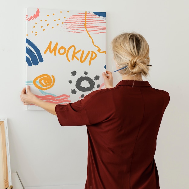 PSD person holding a canvas mock-up