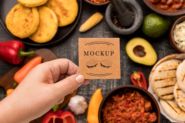 person holding card with food mock-up