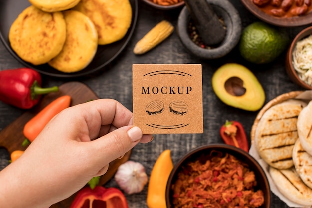 Person holding card with food mock-up