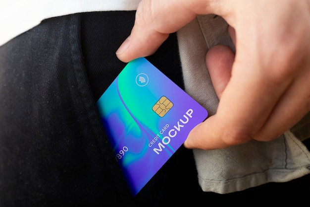 Person holding credit card mock-up in clothing pocket