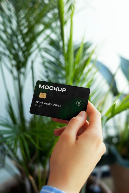 Person holding credit card mock-up in hand