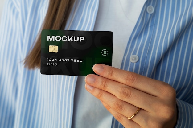 Person holding credit card mock-up in hand