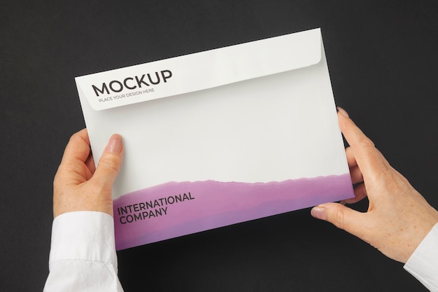 PSD person holding document mock-up in hands