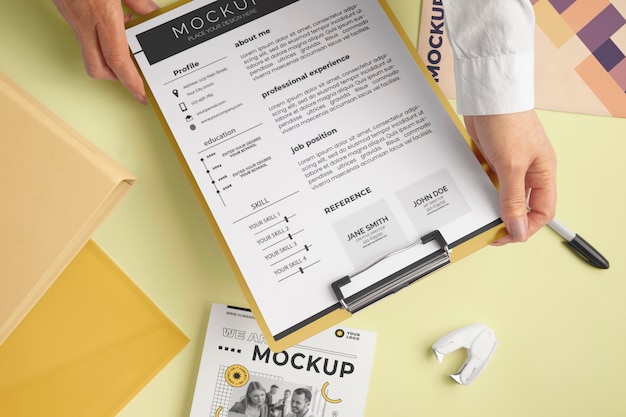 Person holding document mock-up with clipboard