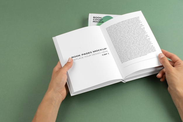 person holding hard cover book in their hands