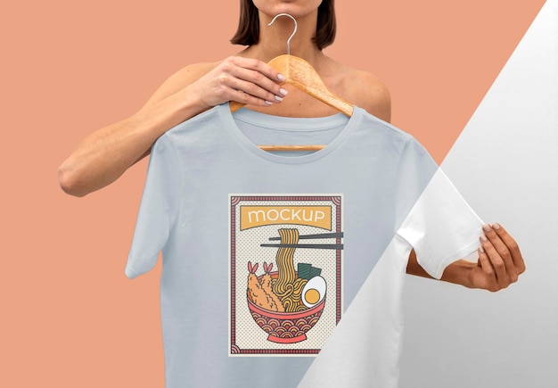 PSD person holding a japanese t-shirt mock-up