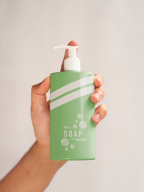 PSD person holding a liquid soap bottle close-up