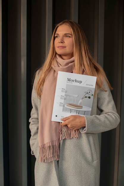 Person holding magazine mockup