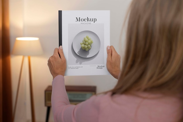 PSD person holding magazine mockup