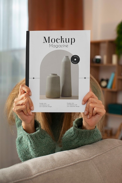 PSD person holding magazine mockup