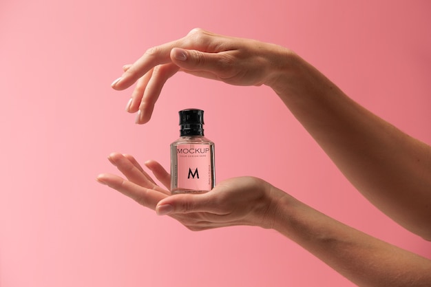 PSD person holding mock-up glass bottle of perfume