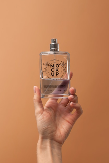 PSD person holding mock-up glass bottle of perfume