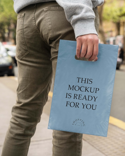 PSD person holding mock-up plastic bag design