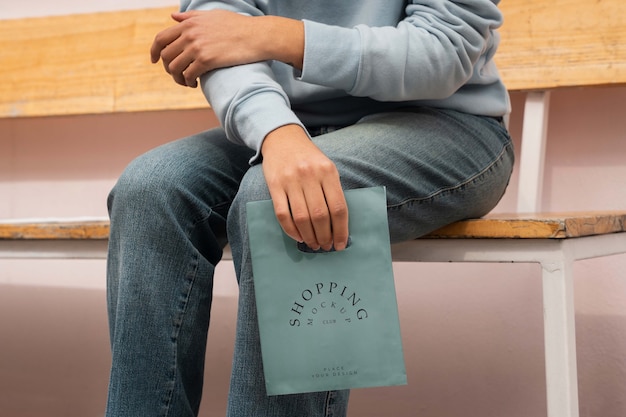 Person holding mock-up plastic bag design