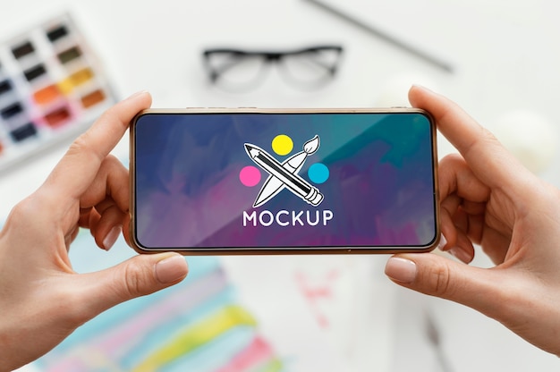person holding a mock-up smartphone