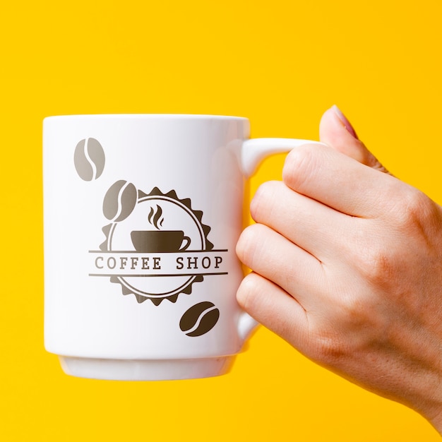 Person holding mug mock-up