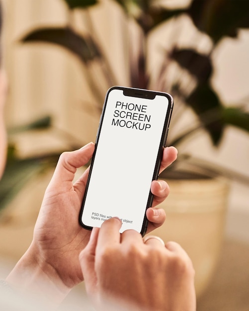 a person holding a phone with screen mockup