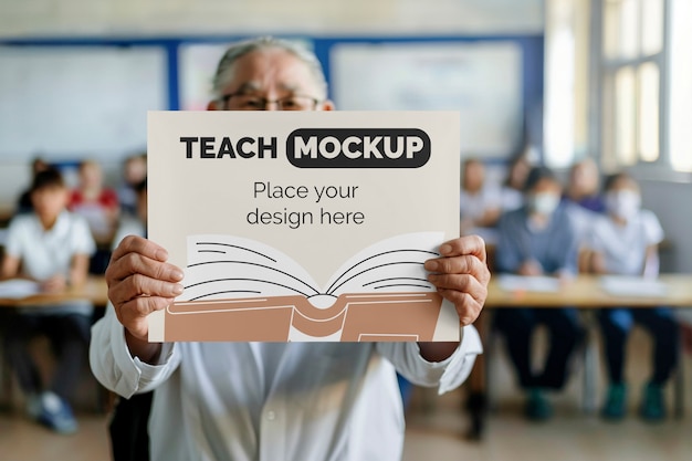 PSD person holding poster mockup in classroom