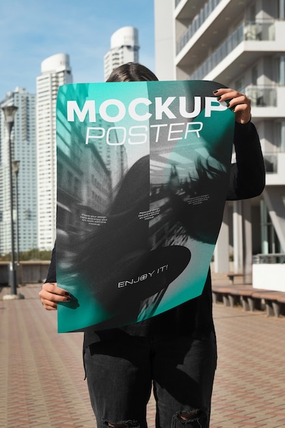 Person holding poster mockup outdoors