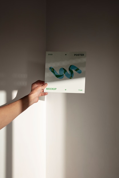 PSD person holding poster mockup