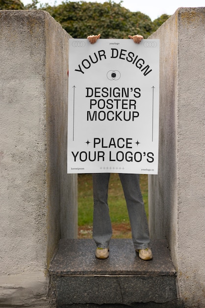 PSD person holding poster mockup